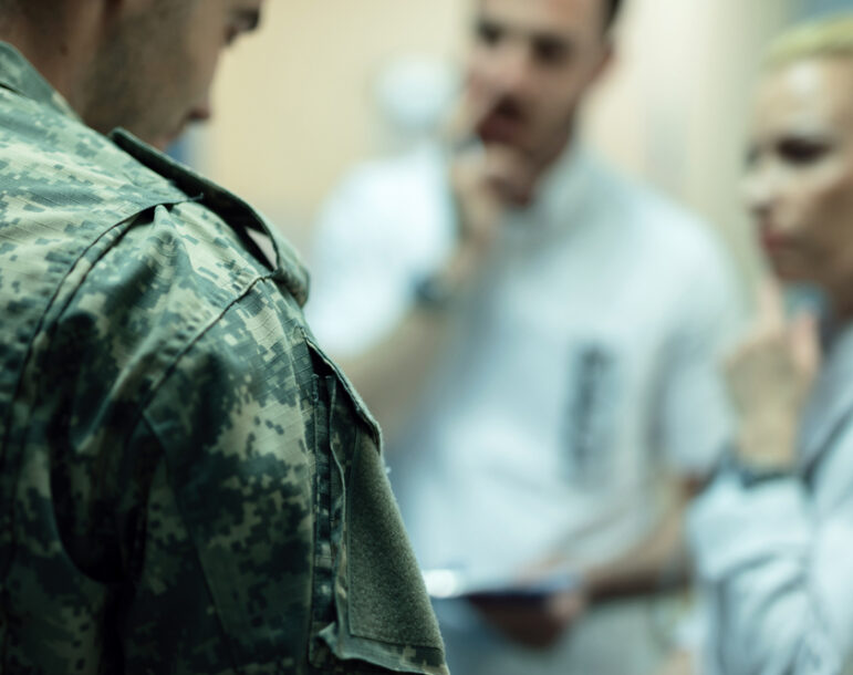 What To Ask Your Veterans Disability Lawyer - Close up of army soldier having doctor's appointment in the hospital.